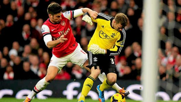 Goalkeeper Artur Boruc of Southampton loses the ball to Olivier Giroud of Arsenal who goes on to score.