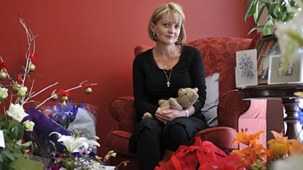 Shani Cassidy at her home yesterday, surrounded by  tributes to her son Tyler, who was shot dead by police last week.