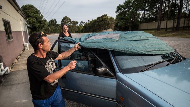 Anthony Cuskelly and his partner Cindy Pryor preparing their vehicle to sleep in.