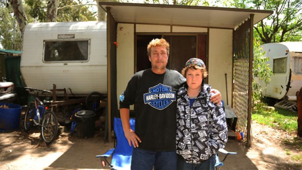 Ricky White and son Harley outside their home at Shawlands Caravan Park in Dandenong. "I don't imagine that I'm always going to be staying here," White says.