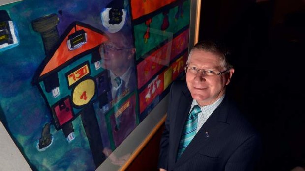 Denis Napthine with a painting by his foster son Jack.
