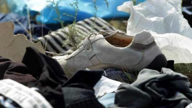 A shoe and other personal items from passengers of flight MH17 at the crash site.