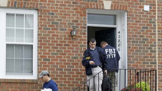 FBI Investigators leave the home of Farooque Ahmed.