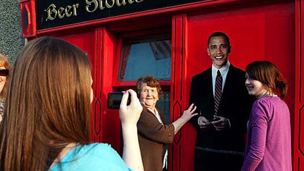 Morale booster: Moneygall locals and tourists pose with an Obama cutout in advance of the presidential visit