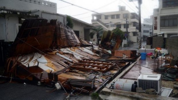 Widespread damage ... A wooden house collapsed during strong winds in Naha on Japan's southern island of Okinawa.