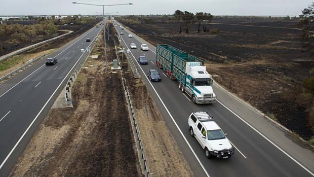 Close call: Fire burned the median strip and either side of the Hume Freeway at Epping. Residents say there was chaos on local roads as people tried to leave the area.