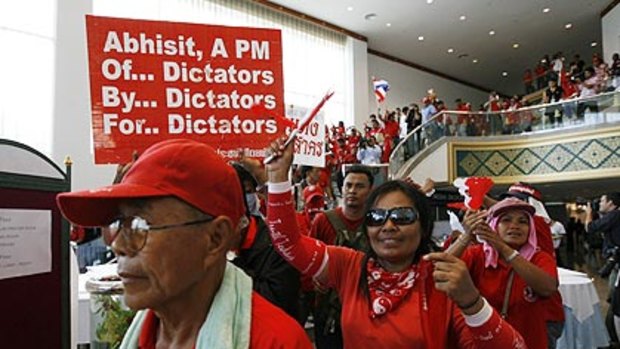 Red-shirted supporters of ousted Thai prime minister Thaksin Shinawatra enter one of the ASEAN venues.