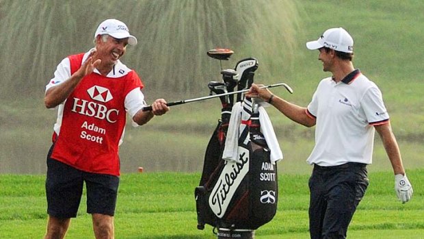 Steve Williams (left) celebrates with his new partner Adam Scott during the World Golf Championships-HSBC Champions golf tournament in Shanghai on November 5. The caddy was reported to have made up with Tiger Woods yesterday.