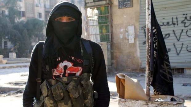 A member of jihadist group Al-Nusra Front stands in a street of the northern Syrian city of Aleppo.