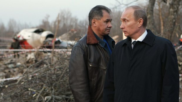 The then Russian prime minister Vladimir Putin and Emergency Situations Minister Sergei Shoigu visit the crash site of the Polish presidential plane near Smolensk on April 10, 2010.