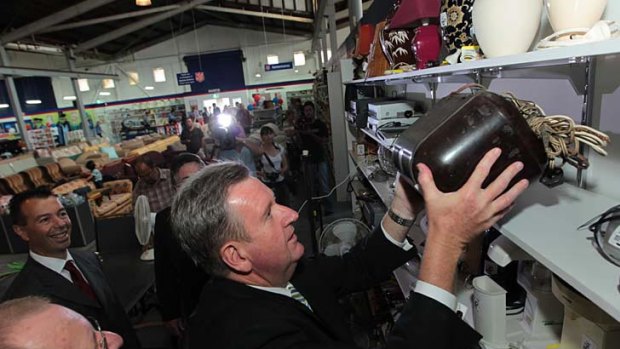 Barry O'Farrell selects and buys an old radio for retiring MP Wayne Merton while opening the Salvos store in Croydon. March 17, 2011.