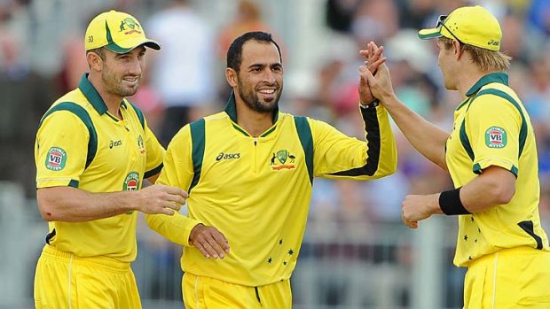 Australia's Fawad Ahmed (C) celebrates taking a T20 wicket for Australia with Shaun Marsh and Shane Watson, August 31, 2013.