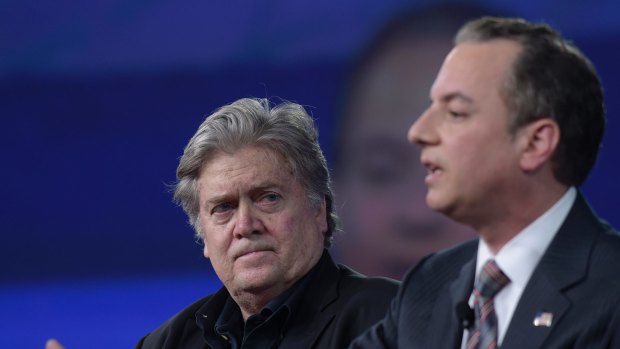 White House strategist Stephen Bannon listens as Reince Priebus speaks.