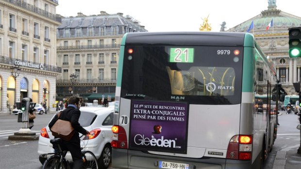 One of the controversial advertisements for an adultery website on a bus in Paris.