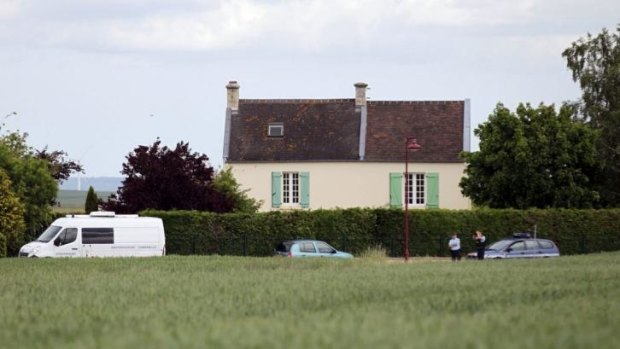 French gendarmes stand in front of a house where Dominique Leboucher, 55, the mayor of Bretteville-le-Rabet was found dead after he was fatally injured by a man who suspected him of having an affair with his wife.