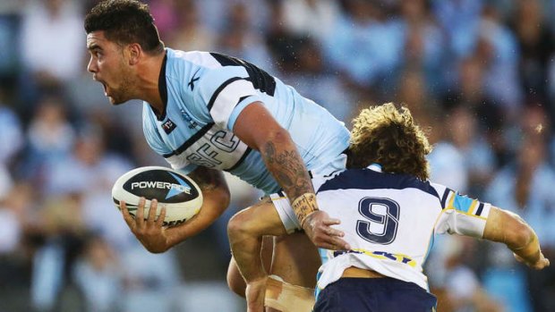 Sharks prop Andrew Fifita is brought down by Titans hooker Beau Falloon on Monday night.