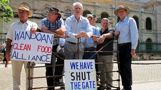 Gate shut ... Friends of the Earth spokesman Drew Hutton (centre) with farmers and action groups outside Parliament House.