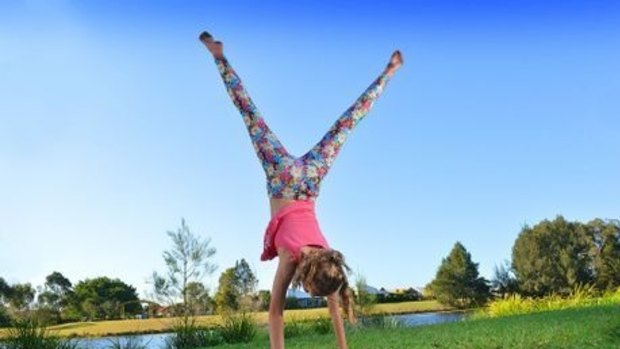 Anna, 11, performs a cartwheel deemed dangerous by a Sunshine Coast school.