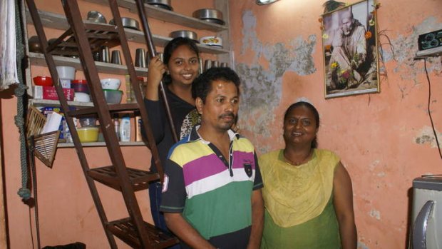 Jeeta Avekar in her flat with her husband and daughter.