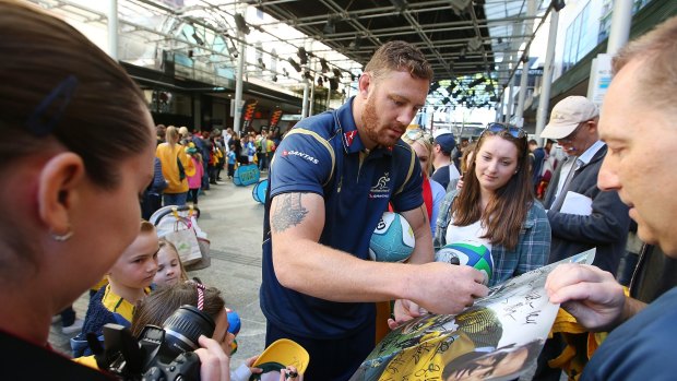 Scott Higginbotham signs autographs during an Australian Wallabies Fan Day at the Queen St Mall Stage 