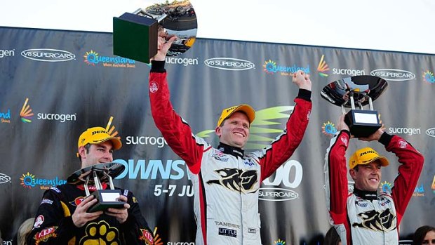 Garth Tander (centre) celebrates with James Courtney (right) and Shane Van Gisbergen after his victory.