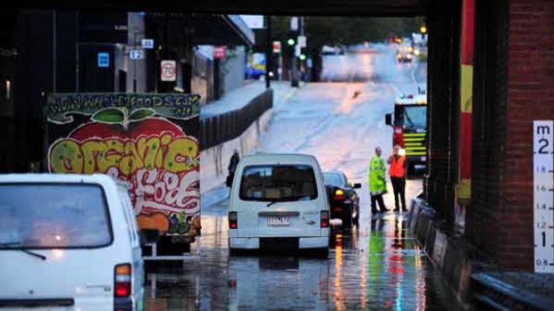 Vehicles get stuck under the Dudley Street bridge after heavy rainfall in Melbourne's CBD.