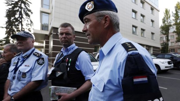 Head of Australian Federal Police mission Commander Brian McDonald (left), OSCE's Alexander Hug (centre), and a Dutch police officer arrive back from the MH17 site on Thursday.
