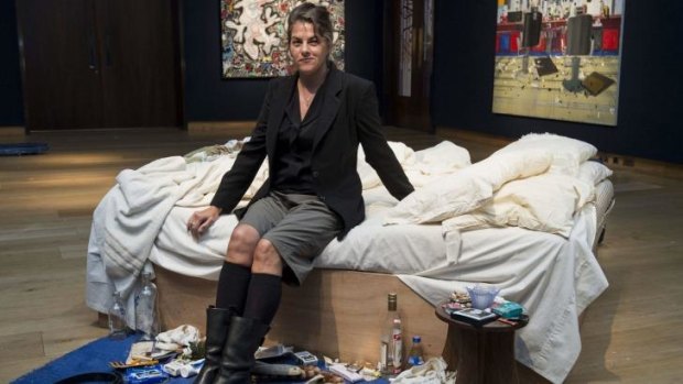 Tracey Emin sits on her iconic art installation, <i>My Bed</i>, which was short-listed for the 1999 Turner Prize.
