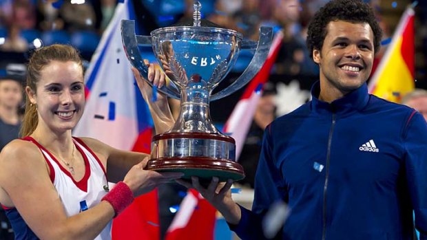 Alize Cornet and Jo-Wilfried Tsonga of France pose with the trophy after winning the Hopman Cup tennis tournament in Perth on Saturday.