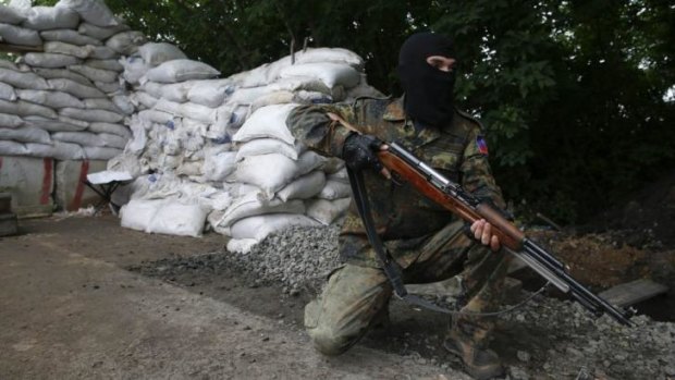 A pro-Russian fighter mans a checkpoint in Donetsk.
