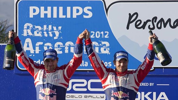 French driver Sebastien Loeb (right) and his co-driver Daniel Elena of Monaco rejoice on the podium.