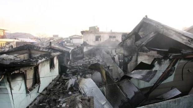Target ... destroyed houses on Yeonpyeong Island.