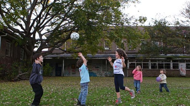 Children play at Callan Park where abandoned buildings containing asbestos sit idle.
