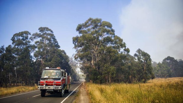 The scene from the Kings Highway. Crews work to contain fires near Bungendore.