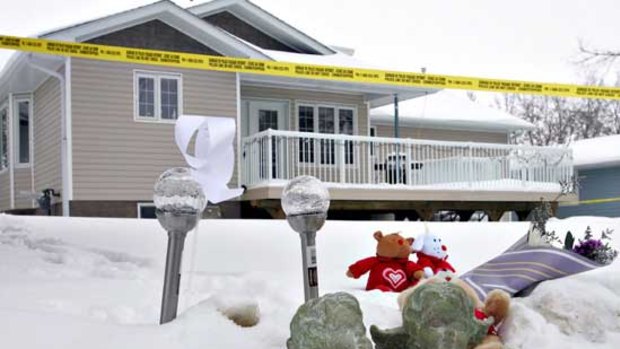 Stuffed animals are seen outside the house near Edmonton, Canada, where Alison McConnell's two young sons were found dead.