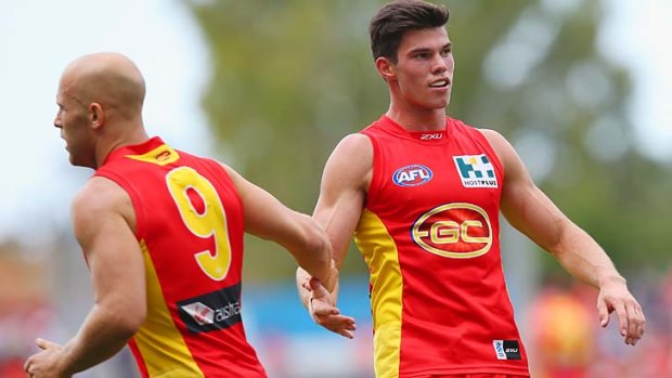 Heir apparent? Jaeger O'Meara of the Suns celebrates a goal with Suns skipper Gary Ablett.