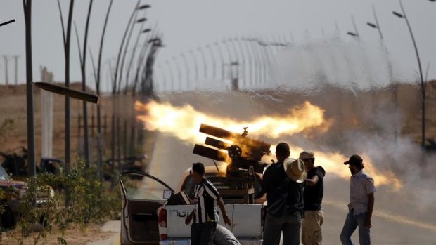 Anti-Gaddafi fighters fire a multiple rocket launcher near Sirt, one of Muammar Gaddafi's last remaining strongholds.