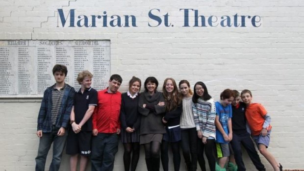 Artistic Director of Marian Street Theatre for Young People, Margie McRae (centre) with kids outside the theatre they hope to be residents of once again. 