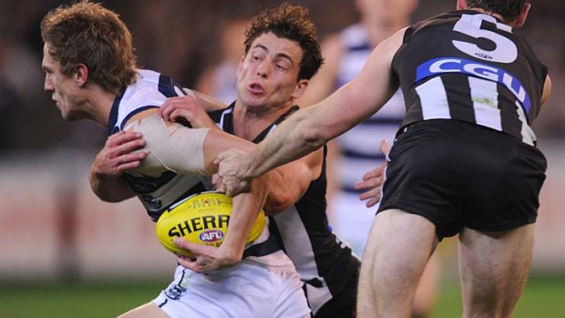 Geelong's Billie Smedts tackled by Collingwood's Jarryd Blair