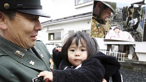 The man who rescued four-month-old Iroha Ishikawa after the tsunami has been reunited with the girl as Japan paused to mark the one-year anniversary of the disaster that killed as many as 19,000 people. The rescue, by Koji Chiba of Japan's Self-Defence Force, was shown around the world.