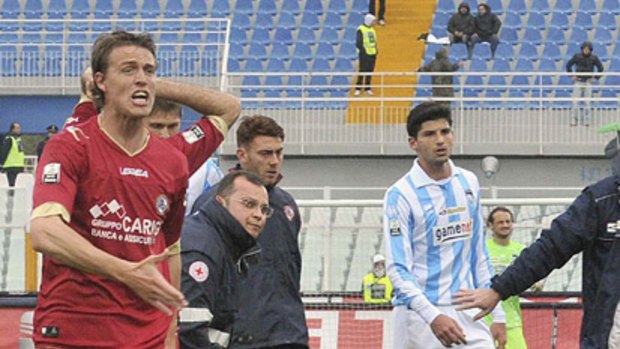 Livorno players react as teammate Piermario Morosini is helped by doctors during their Serie B soccer match against Pescara.