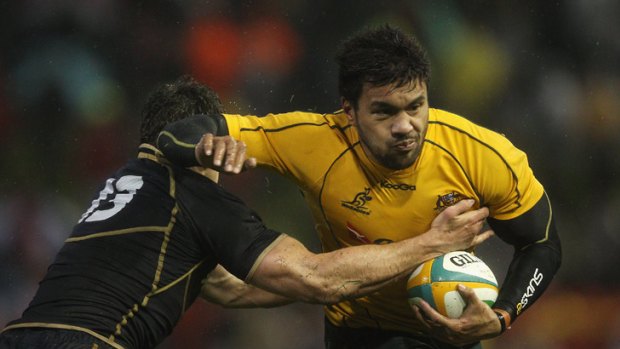 Wallabies and Queensland Reds star Digby Ioane attempts to break a tackle against Scotland in Newcastle this week.
