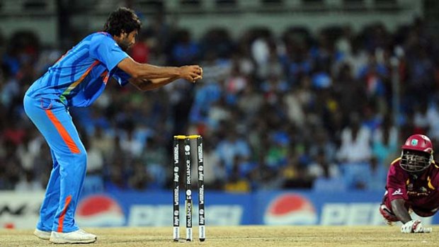Caught short . . . Indian bowler Munaf Patel runs out West Indian skipper Darren Sammy on Sunday night. India now meet Australia on Thursday.