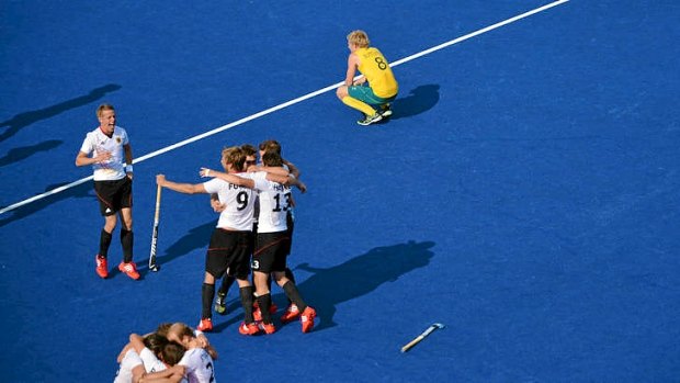 German players celebrate as Australian players Matthew Butturini reacts after their men's field hockey first semi-final at the London Olympics.