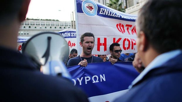 Greek police officers shout slogans during a protest in Athens.