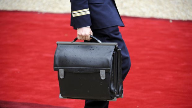 An officer walks with the satchel containing the nuclear codes for France's new President Francois Hollande.