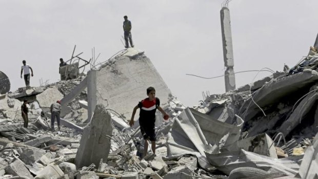 Palestinians search the rubble of homes in Khuza'a.