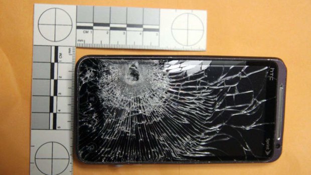 Lucky break ... This mobile phone stopped a bullet fired that was fired at a Hess petrol station clerk during an early morning robbery in a Orlando, Florida suburb. The man had the device in a pocket.
