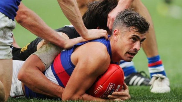 Daniel Giansiracusa of the Bulldogs wins the ball on the ground during the round 14 match against Port Adelaide.