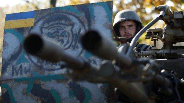 Uneasy truce: A Ukrainian serviceman sits at his anti-aircraft heavy machine gun at a military camp near the town of Debaltseve in eastern Ukraine.